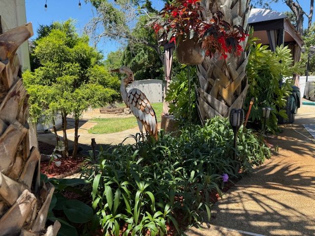 Prayer garden with tropical plants and decorative elements